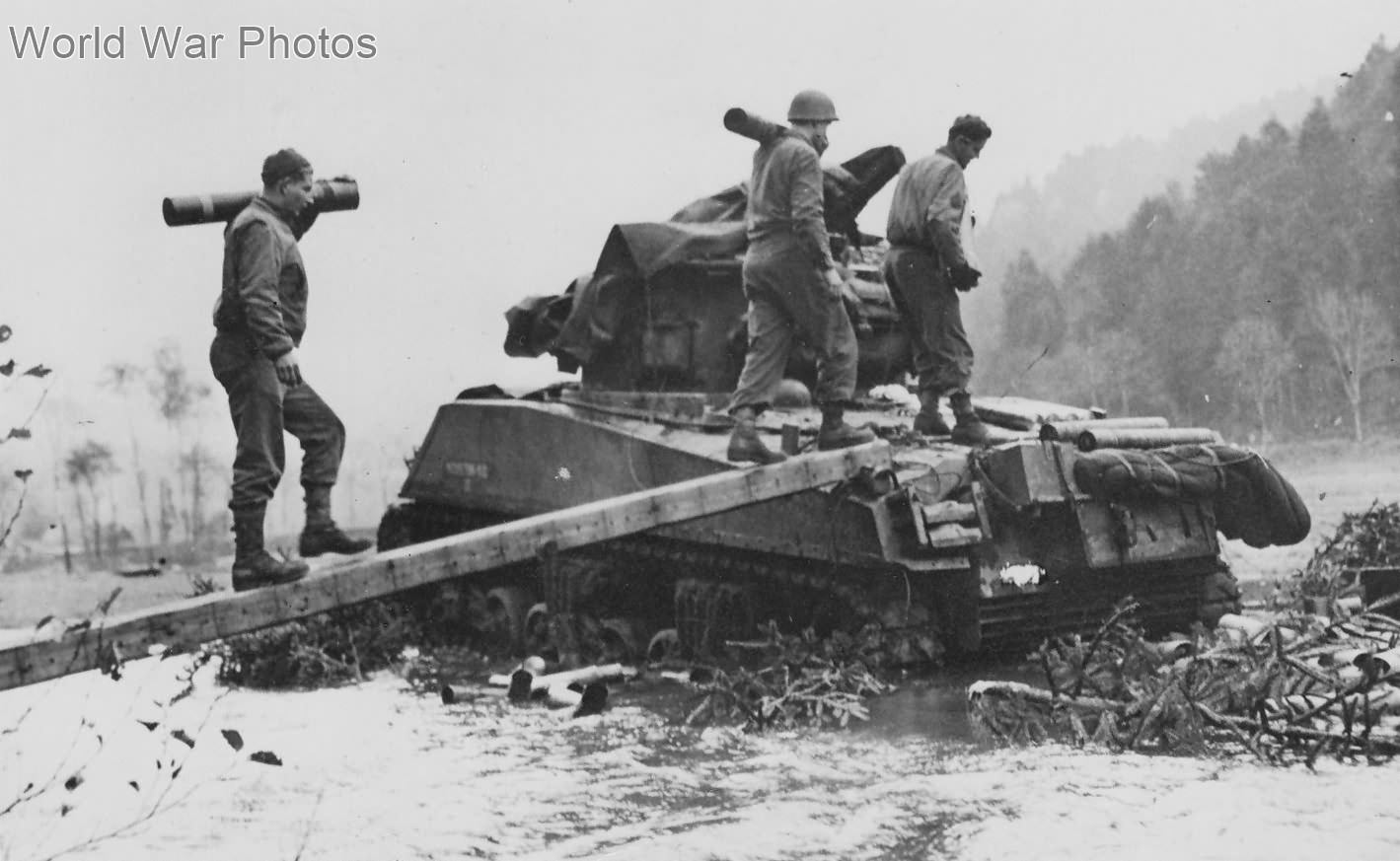 Soldiers bridge flood waters to keep M4 tank firing France, 7th Army