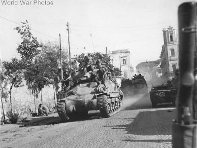 US troops move thru Naples atop M4 September 1943