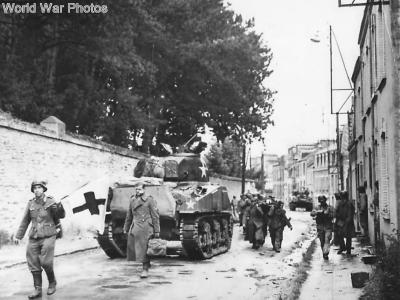 Wounded prisoners march thru Cherbourg with red cross flag