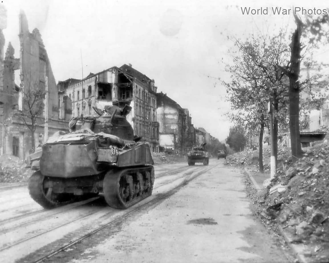 Shermans moving thru streets of Aachen