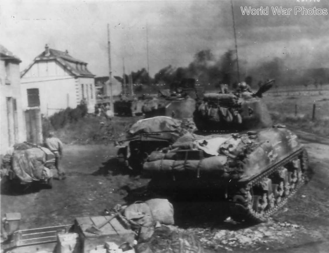 U.S. Shermans ready to move against trapped German infantry near Gelin, Belgium 1944
