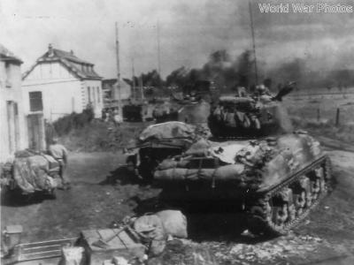 U.S. Shermans ready to move against trapped German infantry near Gelin, Belgium 1944