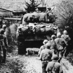 Troops advance under cover of a Sherman tank, Metz September 1944