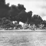 Light Cruiser USS Phoenix (CL-46) passes burning USS Arizona Pearl Harbor