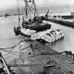 Salvage crews work to raise the minelayer USS Oglala which was sunk during Japanese attack on Peral Harbor 1942