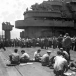 Sailors eat on deck of the USS Bunker Hill (CV-17)