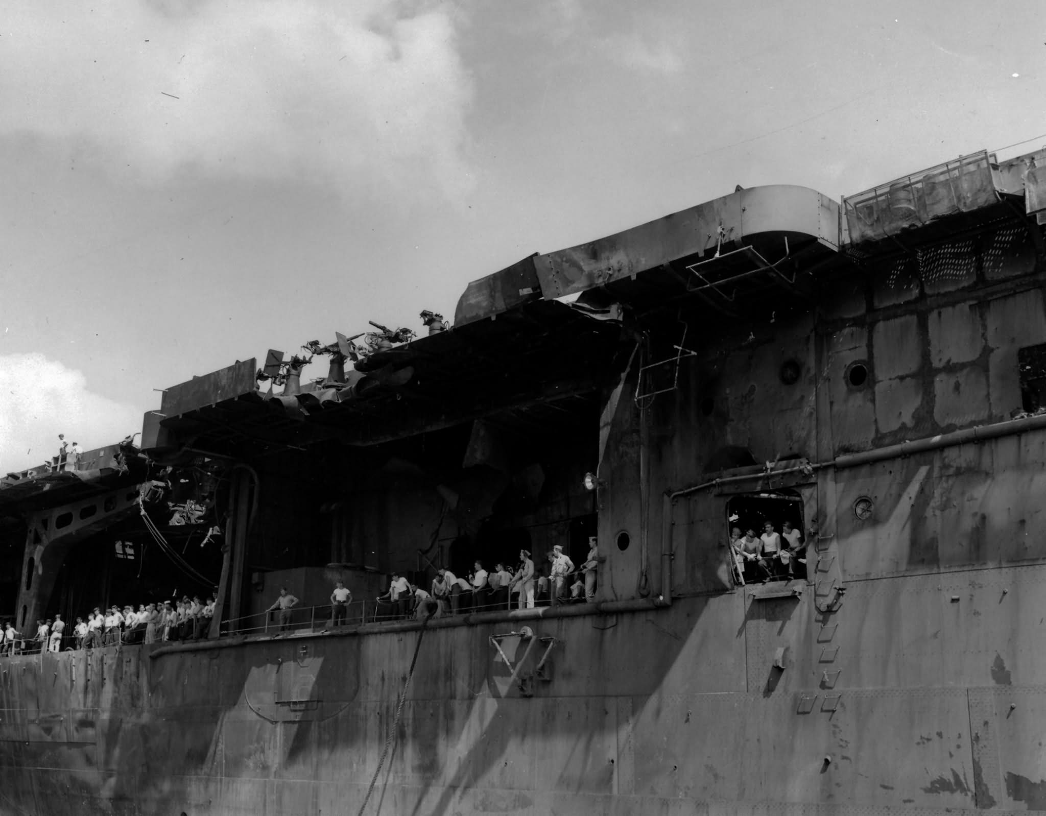 Surviving crewmen gather on board the aircraft carrier USS Franklin