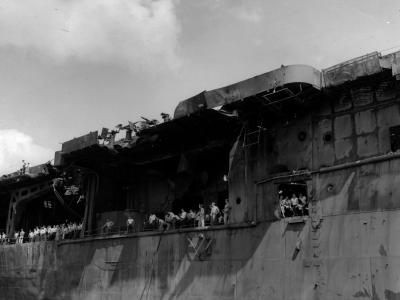 Surviving crewmen gather on board the aircraft carrier USS Franklin