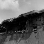 Surviving crewmen gather on board the aircraft carrier USS Franklin