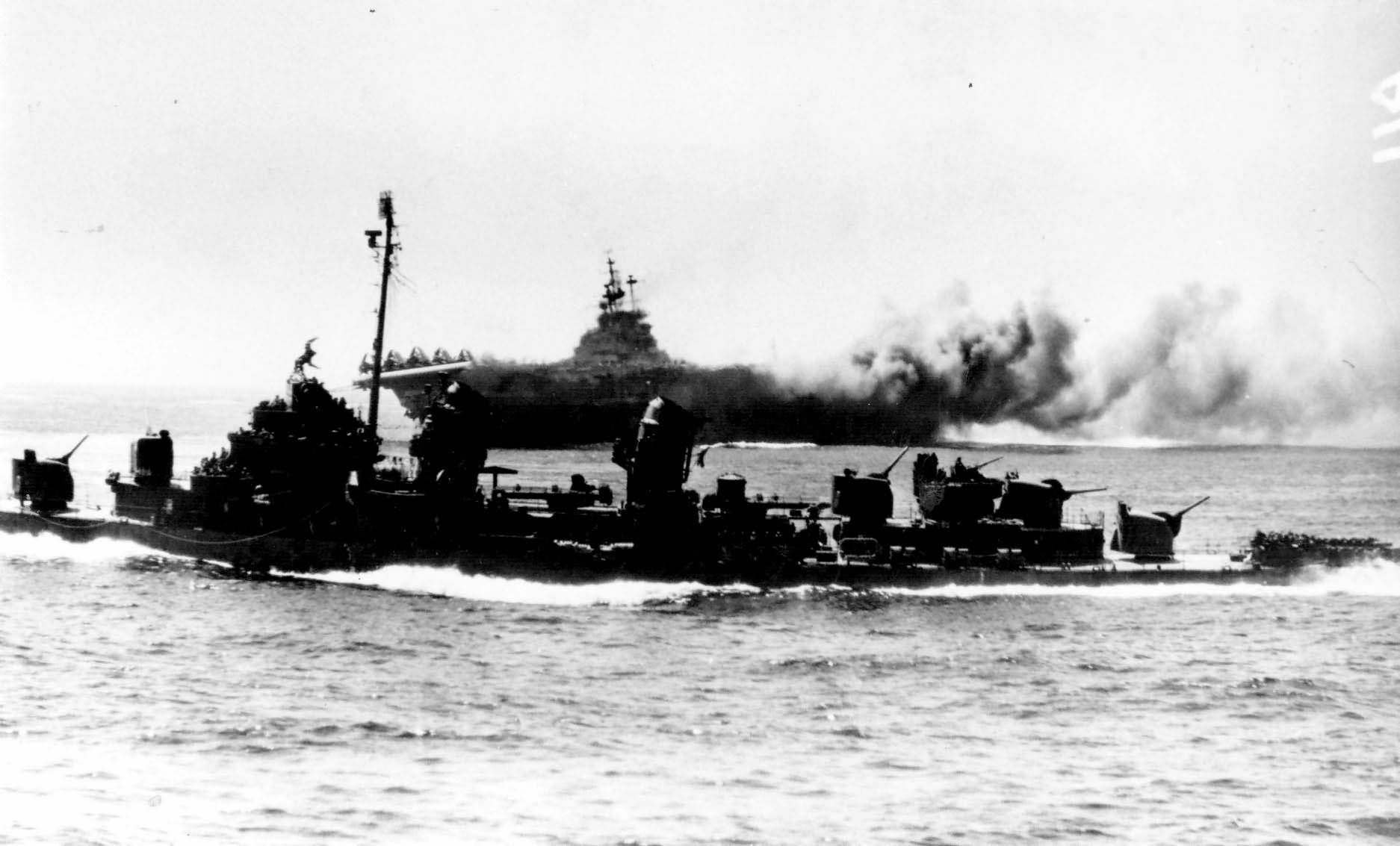 Destroyer steams off the carrier USS Intrepid CV-11, 16 April 1945