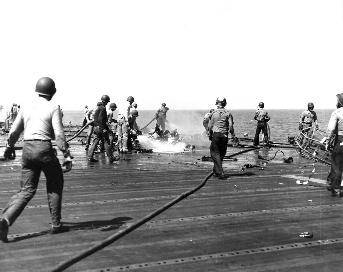 Sailors fight fires on board a battle damaged USS Intrepid 2