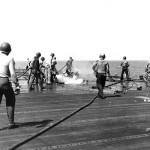 Sailors fight fires on board a battle damaged USS Intrepid 2