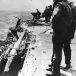 Crew inspects damage to gun gallery on USS Lexington during Battle of Coral Sea