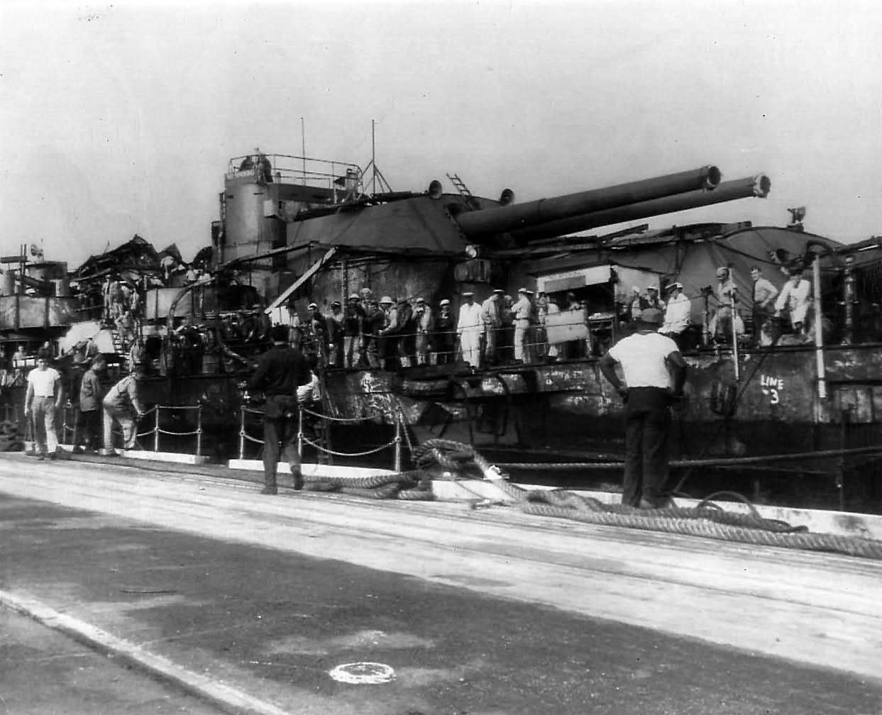 Sailors aboard raised USS Oklahoma in dry dock at Pearl Harbor 1944