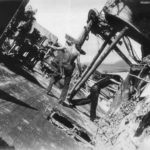 Navy personnel on tilted deck of USS Oklahoma