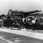 Sailors aboard raised USS Oklahoma in dry dock at Pearl Harbor 1944