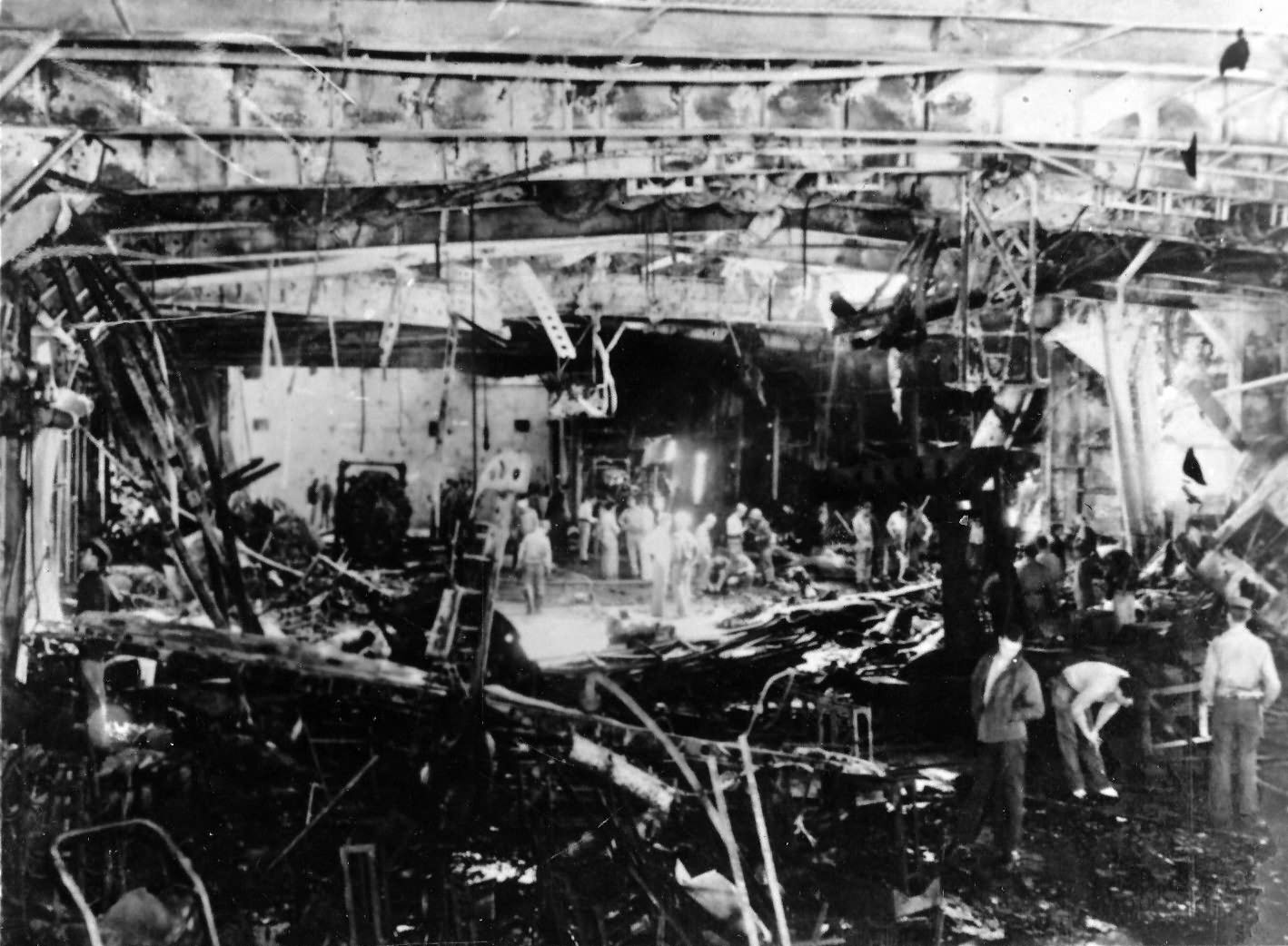 Wreckage on hangar deck escort carrier USS Sangamon after a kamikaze attack