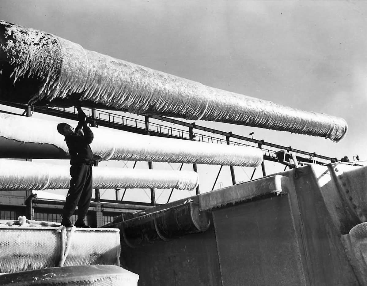Sailor chops ice from 406 mm (16 inches) guns of USS Washington BB-56