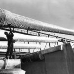 Sailor chops ice from 406 mm (16 inches) guns of USS Washington BB-56