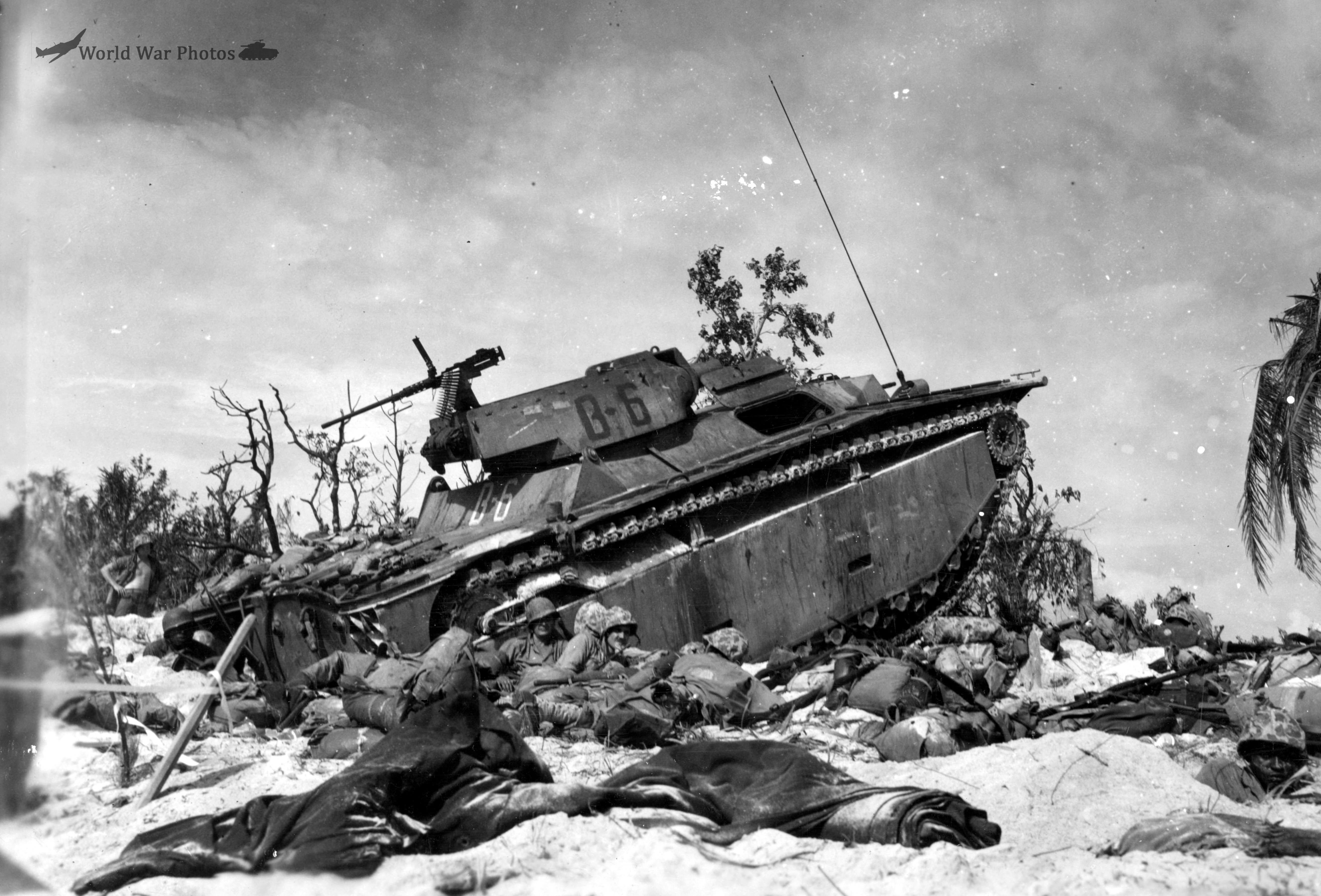 Marines sit by amphibious tractor LVT-4