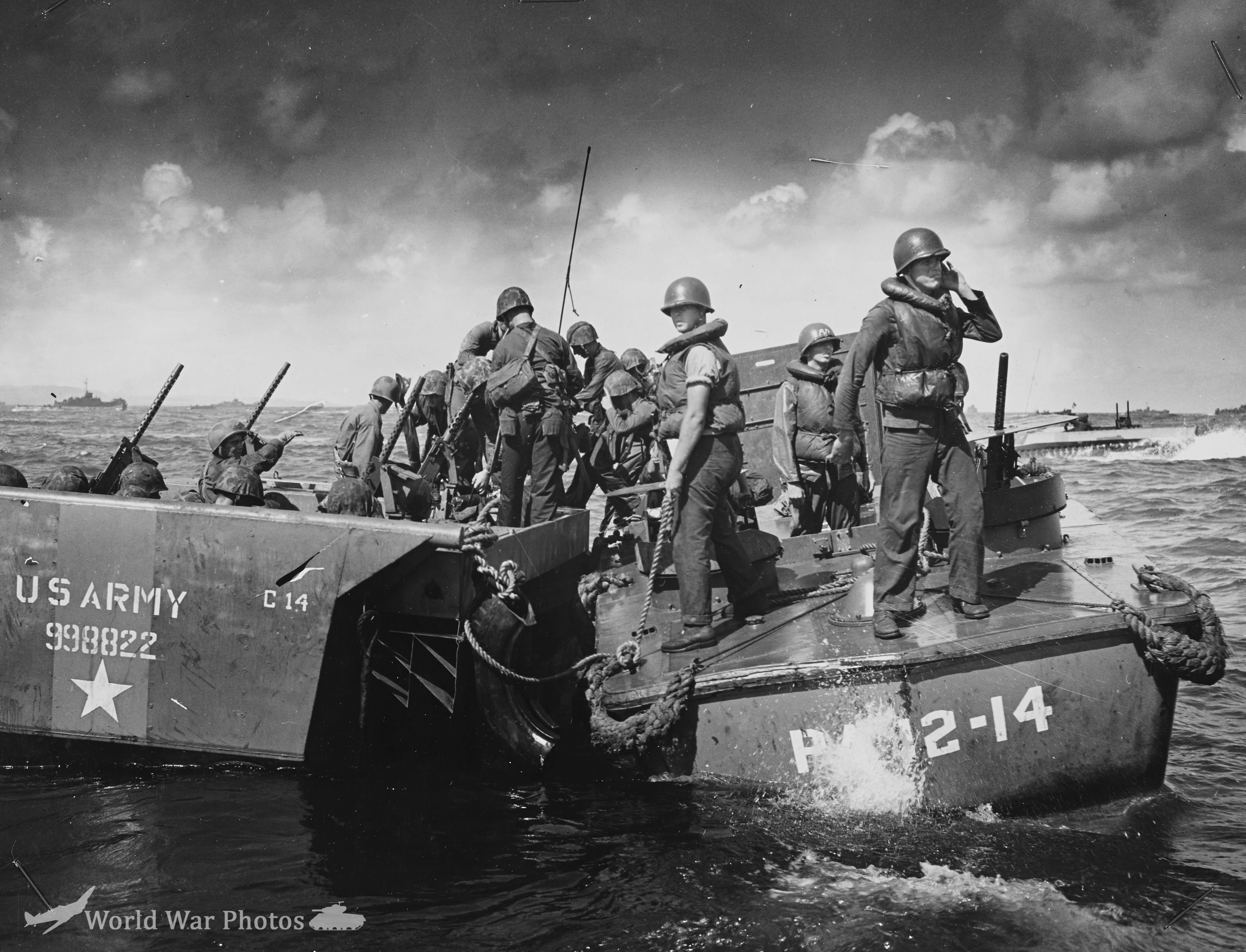 Smashed by a direct hit from Jap shore batteries at Saipan an Army amtrac is sinking