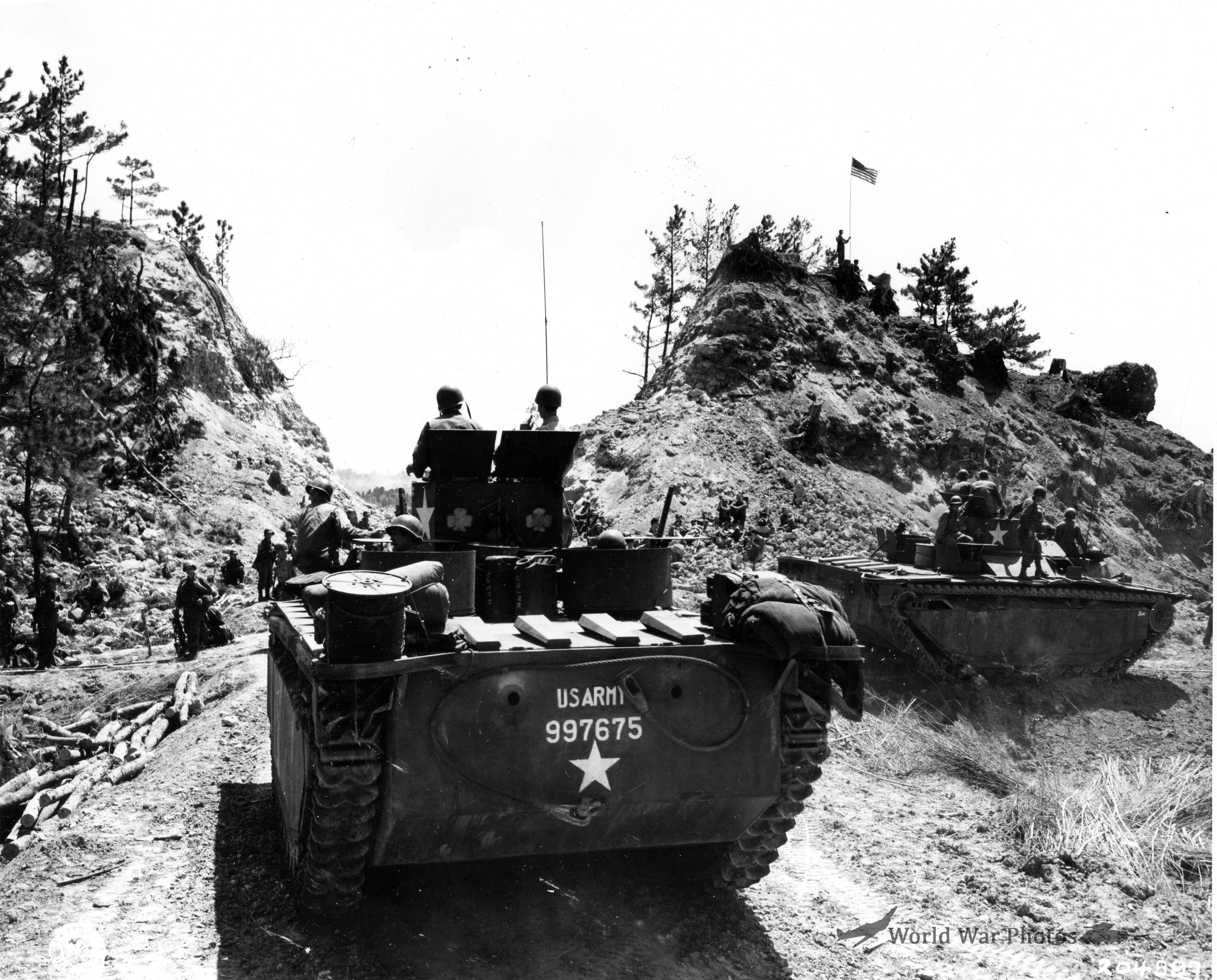Troops of 96th Division pause at the pass leading to Chatan village Okinawa