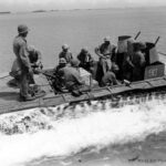LVT-2 pulls away from LCM with rations headed for the frontlines Saipan