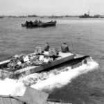 LVT-4 loaded with supplies removed from an LSVP heads for the beach of Okinawa