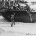 Quickly disembarking from tractor attacking inland 10 March 1944