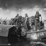 Smashed by a direct hit from Jap shore batteries at Saipan an Army amtrac is sinking