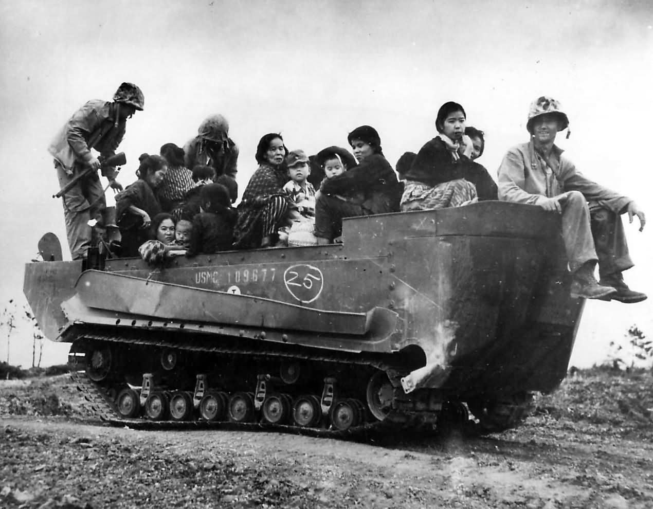 Marines carry women and children To Safety in M29C Weasel on Okinawa, 1945