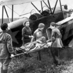Wounded Russian soldier being loaded onto a Polikarpov U-2 / Po-2 ambulance plane by nurses