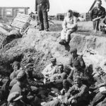Battered Russian POWs gathered in ditch by Wehrmacht captors
