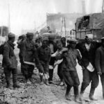 Russian soldiers support wounded comrades after German capture 1941