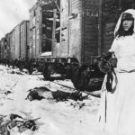 Soviet soldier stands guard among fallen Nazi troops 42