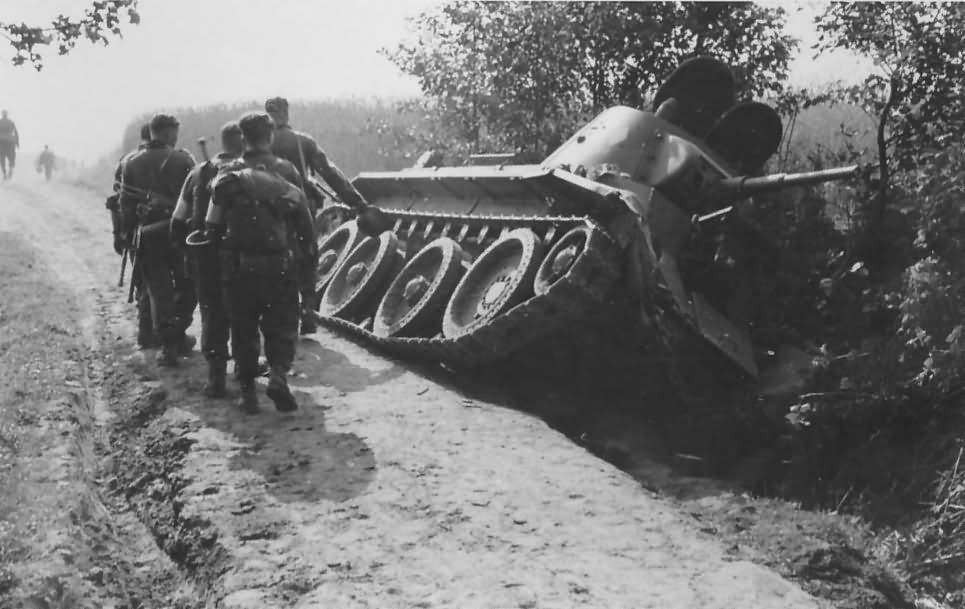 Soviet tank BT-7 lying on its side in a ditch