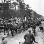 French forced laborers are passing the column of IS-2 tanks