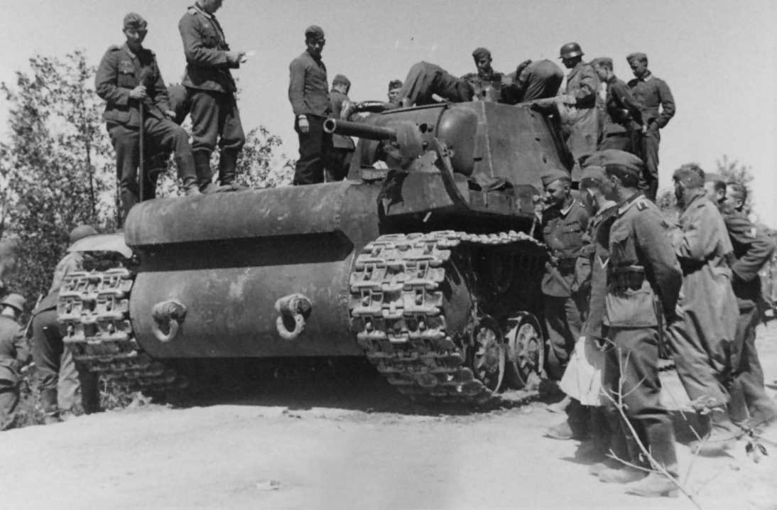 Wehrmacht soldiers examining KV1 tank