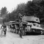 Wehrmacht troops examining russian KV 1 tank on road