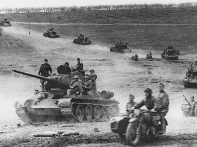A column of Soviet motorcycles and T-34/85