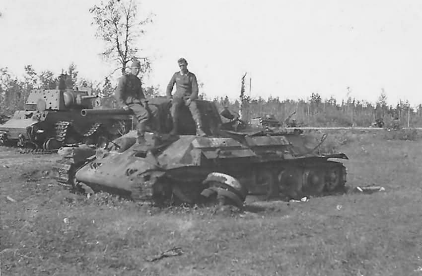 A german soldiers sit on the front of a captured T-34 tank. Meschew Eastern Front 1941