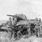 Wehrmacht soldiers next to a tank T-34 model 1941